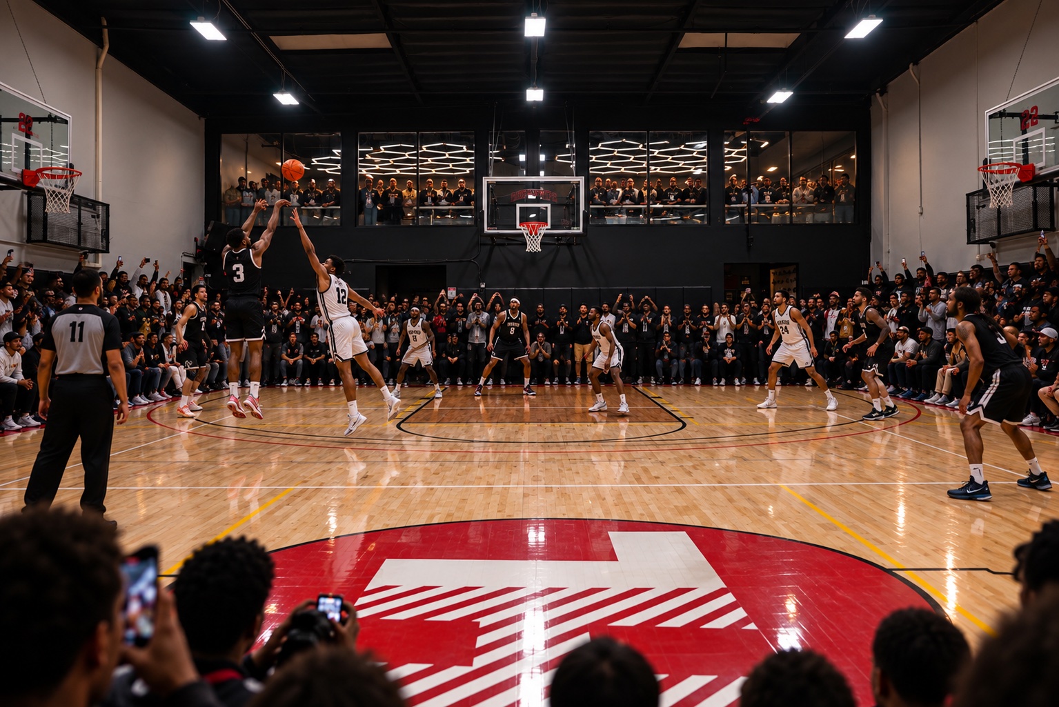 A basketball game with spectators around the court and on the mezzanine