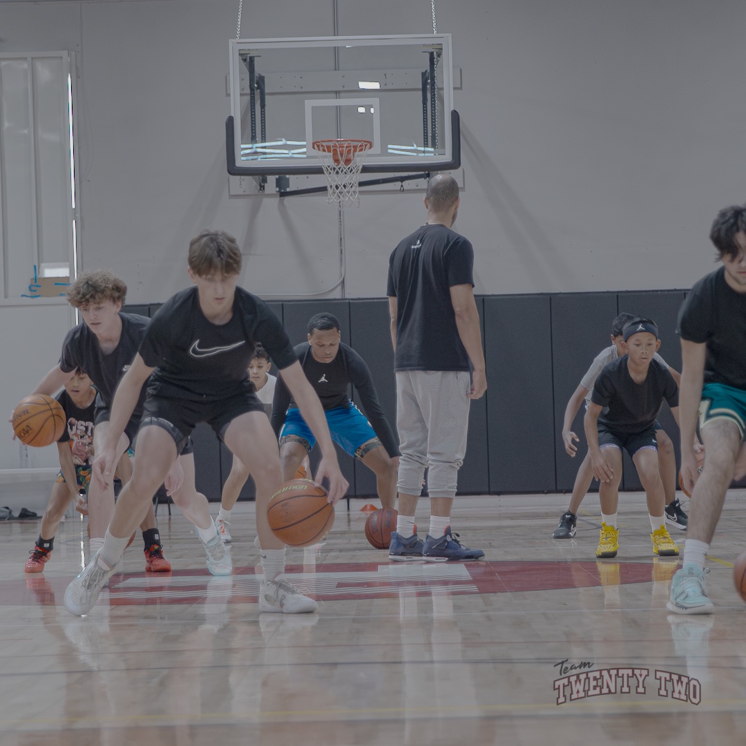 Team TwentyTwo players working on dribbling fundamentals with a coach at Hoop Legends